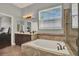 Bathroom features double sinks, a soaking tub and large window at 1657 Tennyson Ct, Lake Mary, FL 32746