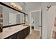 Bathroom features a large mirror with vanity and entrance to another room at 1657 Tennyson Ct, Lake Mary, FL 32746