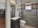 Well-lit bathroom featuring a glass-enclosed shower, granite countertop, and modern fixtures at 1657 Tennyson Ct, Lake Mary, FL 32746