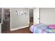 Bedroom with wood floors features a large closet and view of connecting room at 1657 Tennyson Ct, Lake Mary, FL 32746