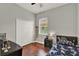 Bedroom features wood floors, large closet and window with blinds at 1657 Tennyson Ct, Lake Mary, FL 32746