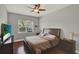 Comfortable bedroom features a ceiling fan, wood floors, and a window providing natural light at 1657 Tennyson Ct, Lake Mary, FL 32746