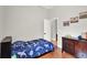 Cozy bedroom with hardwood floors, decor, and a door leading to the hallway at 1657 Tennyson Ct, Lake Mary, FL 32746