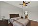Cozy bedroom with wood floors, ceiling fan and a view of the ensuite bathroom at 1657 Tennyson Ct, Lake Mary, FL 32746