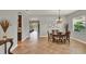 Bright dining room with decorative chandelier, gray walls, and tile flooring at 1657 Tennyson Ct, Lake Mary, FL 32746