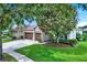 Charming single-story home with a well-manicured lawn, mature tree, and a two-car garage at 1657 Tennyson Ct, Lake Mary, FL 32746