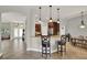 A kitchen with granite countertops, bar seating, stainless appliances, and views to living areas at 1657 Tennyson Ct, Lake Mary, FL 32746