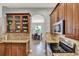 Kitchen featuring granite counters, wood cabinets, stainless appliances, and seamless flow into dining at 1657 Tennyson Ct, Lake Mary, FL 32746