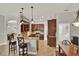 Open kitchen featuring granite counters, wood cabinets, pendant lighting, and a breakfast bar at 1657 Tennyson Ct, Lake Mary, FL 32746