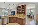 Open kitchen featuring granite countertops, wood cabinetry, and seamless flow to dining areas at 1657 Tennyson Ct, Lake Mary, FL 32746