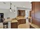 Spacious kitchen boasting granite counters, wood cabinets, breakfast bar, and seamless flow to dining at 1657 Tennyson Ct, Lake Mary, FL 32746