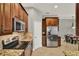 Kitchen featuring stainless appliances, wood cabinets, tile floors, and granite countertops at 1657 Tennyson Ct, Lake Mary, FL 32746