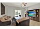 Bright Gathering room with sliding glass doors leading to pool and media center with large screen tv at 1657 Tennyson Ct, Lake Mary, FL 32746