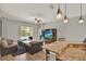 Open living space with breakfast bar overlooking sitting area, a media center, and access to backyard pool at 1657 Tennyson Ct, Lake Mary, FL 32746