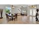Open-concept living and dining area with tile floors, offering a seamless flow for entertaining at 1657 Tennyson Ct, Lake Mary, FL 32746
