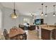 Open living space showing breakfast bar, living room, and dining table, flooded with light at 1657 Tennyson Ct, Lake Mary, FL 32746