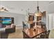 Open living space with view to breakfast bar, media center, and dining table at 1657 Tennyson Ct, Lake Mary, FL 32746
