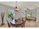 Open-concept living space includes a dining area and sitting area with neutral colors and ample natural light at 1657 Tennyson Ct, Lake Mary, FL 32746