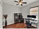 Home office with hardwood floors, ceiling fan, and dual monitor setup at 1657 Tennyson Ct, Lake Mary, FL 32746