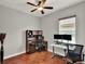 Well-equipped home office featuring hardwood floors, ceiling fan, and a spacious workspace at 1657 Tennyson Ct, Lake Mary, FL 32746