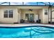 Enclosed pool area with outdoor seating, a basketball hoop, and an attached patio at 1657 Tennyson Ct, Lake Mary, FL 32746