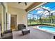 Relaxing screened-in pool patio with ample seating and a view of the well-manicured backyard at 1657 Tennyson Ct, Lake Mary, FL 32746