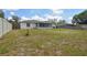 Expansive backyard featuring lush grass, a well-maintained fence, and a screened-in porch at 1668 Fort Smith Blvd, Deltona, FL 32725