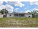 A wide shot of the backyard, featuring a view of the home's screened-in patio and large lawn at 1668 Fort Smith Blvd, Deltona, FL 32725