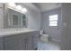 This bathroom has a gray vanity with a quartz countertop and double sinks at 1668 Fort Smith Blvd, Deltona, FL 32725