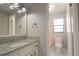 This bathroom features a granite countertop, white cabinets, and a toilet in a separate room at 1668 Fort Smith Blvd, Deltona, FL 32725