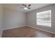 This bedroom features wood floors, a ceiling fan, and a window for natural light at 1668 Fort Smith Blvd, Deltona, FL 32725