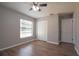 This bedroom features hardwood floors, a ceiling fan, a window, and a closet at 1668 Fort Smith Blvd, Deltona, FL 32725