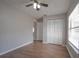This spacious bedroom features hardwood floors, a ceiling fan, and a double-door closet at 1668 Fort Smith Blvd, Deltona, FL 32725