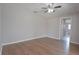 This bedroom features hardwood floors, a ceiling fan, and a door leading to another room at 1668 Fort Smith Blvd, Deltona, FL 32725