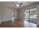 This bedroom features hardwood floors and sliding glass doors leading to an enclosed patio at 1668 Fort Smith Blvd, Deltona, FL 32725