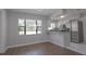 Dining area featuring a breakfast bar, stainless steel appliances, and a large window for natural light at 1668 Fort Smith Blvd, Deltona, FL 32725