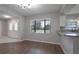 Dining area featuring wood floors, a breakfast bar, and a large window for natural light at 1668 Fort Smith Blvd, Deltona, FL 32725