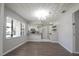 Dining room area featuring wood floors, a modern chandelier, and an open kitchen at 1668 Fort Smith Blvd, Deltona, FL 32725