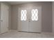 View of front door with diamond windows and marble floors at 1668 Fort Smith Blvd, Deltona, FL 32725