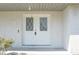 Eye-level shot of a white double door entry with diamond-shaped windows at 1668 Fort Smith Blvd, Deltona, FL 32725