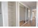 This hallway features a linen closet and mirrored closets leading to another room at 1668 Fort Smith Blvd, Deltona, FL 32725