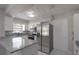 Kitchen area featuring stainless steel appliances, granite countertops, and white cabinetry at 1668 Fort Smith Blvd, Deltona, FL 32725