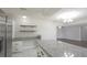 Kitchen featuring granite countertops, stainless steel appliances, and floating shelves at 1668 Fort Smith Blvd, Deltona, FL 32725