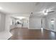 Open living room featuring wood floors, neutral walls, an open kitchen, and a ceiling fan at 1668 Fort Smith Blvd, Deltona, FL 32725