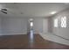 View of an open living room featuring hardwood floors and a white front door at 1668 Fort Smith Blvd, Deltona, FL 32725