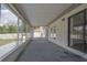 View of the screened-in porch, showing access to the backyard and exterior doors to inside at 1668 Fort Smith Blvd, Deltona, FL 32725