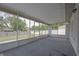 Spacious screened-in porch perfect for enjoying the outdoors, featuring carpeted floors and backyard views at 1668 Fort Smith Blvd, Deltona, FL 32725