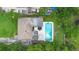Birds-eye view of a house with a pool and patio surrounded by trees and neighboring houses at 1805 Paloma Ave, Sanford, FL 32771