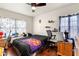 Cozy bedroom with ceiling fan, hardwood floors, and natural light offers a restful retreat at 1805 Paloma Ave, Sanford, FL 32771