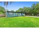 Charming single-story home with a vibrant blue exterior and a well-manicured front lawn at 1805 Paloma Ave, Sanford, FL 32771